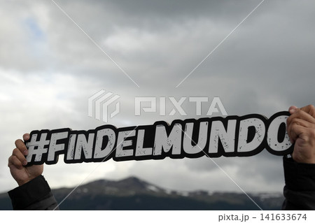ushuaia fin del mundo sign holded by tourist 141633674