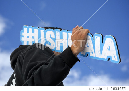 ushuaia sign holded by tourist ushuaia sign holded by tourist 141633675