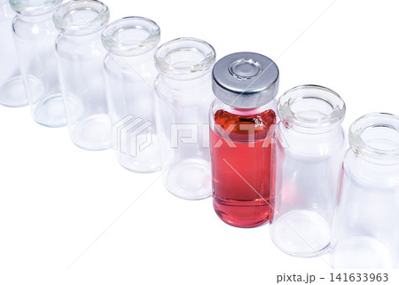 Phial with red vaccine in the row of empty vials Phial with red vaccine in the row of empty vials 141633963