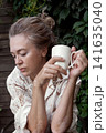 Mature woman with vitiligo skin and gray hair.  Female with autoimmune disease. pigmentation.  scene radiates tranquility, self love, and body positivity, capturing the essence of embracing  141635040