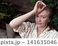Mature woman with vitiligo skin and gray hair.  Female with autoimmune disease. pigmentation.  scene radiates tranquility, self love, and body positivity, capturing the essence of embracing  141635046