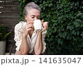 Mature woman with vitiligo skin and gray hair.  Female with autoimmune disease. pigmentation.  scene radiates tranquility, self love, and body positivity, capturing the essence of embracing  141635047