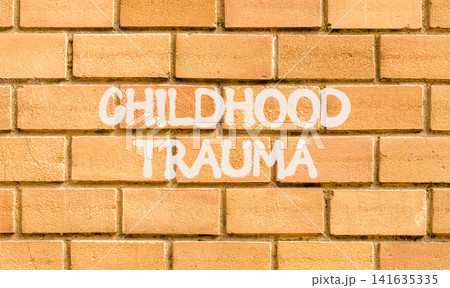 Childhood trauma words symbol. Concept words Childhood trauma on beautiful brick wall. Beautiful brick wall background. Psychological childhood trauma support concept. Copy space. 141635335