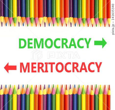 Democracy or meritocracy words symbol. Concept words Democracy Meritocracy on beautiful white paper. Beautiful white background. Colored pencils. Business democracy meritocracy concept. Copy space Democracy or meritocracy words symbol. Concept words Democracy Meritocracy on beautiful white paper. Beautiful white background. Colored pencils. Business democracy meritocracy concept. Copy space 141635340