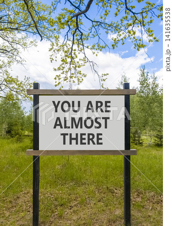 You are almost there words symbol. Concept words You are almost there on beautiful white road sign. Beautiful forest background. Business You are almost there motivational support concept. Copy space You are almost there words symbol. Concept words You are almost there on beautiful white road sign. Beautiful forest background. Business You are almost there motivational support concept. Copy space 141635538