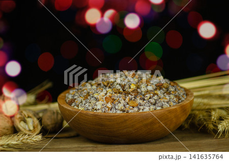 Close up composition emphasizes traditional ingredients and festive atmosphere. Ukrainian Christmas kutya with traditional ingredients. Sweet wheat kutya prepared for Ukrainian Christmas celebration Close up composition emphasizes traditional ingredients and festive atmosphere. Ukrainian Christmas kutya with traditional ingredients. Sweet wheat kutya prepared for Ukrainian Christmas celebration 141635764