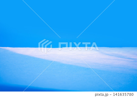 Abstract bright snowy background with copy space. Winter garden landscape with snowdrifts. 141635780