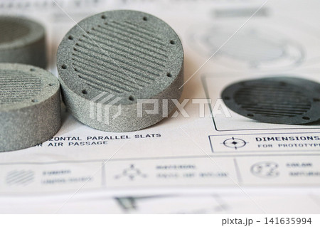 MJF 3D printed parts with ridged pattern on technical blueprint background MJF 3D printed parts with ridged pattern on technical blueprint background 141635994