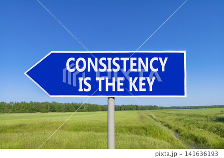 Consistency is the key symbol. Concept words Consistency is the key on beautiful blue road sign. Beautiful blue sky green field background. Business consistency is the key concept. Copy space. Consistency is the key symbol. Concept words Consistency is the key on beautiful blue road sign. Beautiful blue sky green field background. Business consistency is the key concept. Copy space. 141636193