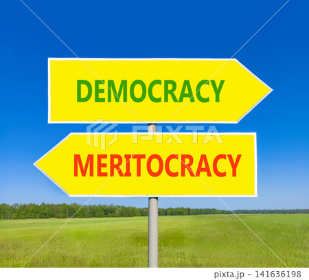 Democracy or meritocracy words symbol. Concept words Democracy Meritocracy on beautiful yellow road sign. Beautiful blue sky background. Business democracy meritocracy concept. Copy space Democracy or meritocracy words symbol. Concept words Democracy Meritocracy on beautiful yellow road sign. Beautiful blue sky background. Business democracy meritocracy concept. Copy space 141636198