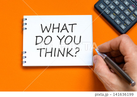 What do you think symbol. Concept words What do you think on beautiful white note. Beautiful orange background. Businessman hand. Business What do you think motivational support concept. Copy space. 141636199