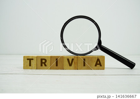 TRIVIA alphabet letters with magnifying glass on wooden background 141636667