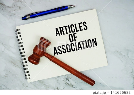 Articles of Corporation text written on notepad with pen and judge gavel on marble background Articles of Corporation text written on notepad with pen and judge gavel on marble background 141636682