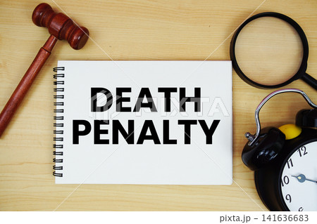 Death Penalty text written on notepad with pen, alarm clock and judge gavel on wooden background Death Penalty text written on notepad with pen, alarm clock and judge gavel on wooden background 141636683