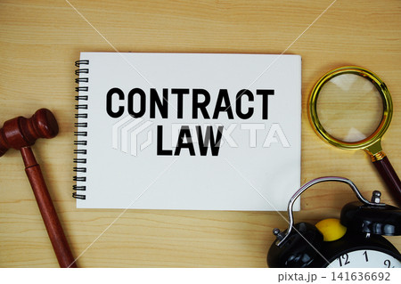 Contract Law text written on notepad with pen, alarm clock and judge gavel on wooden background 141636692