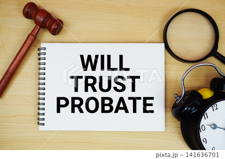 Will Trust Probate text written on notepad with pen, alarm clock and judge gavel on wooden background 141636701