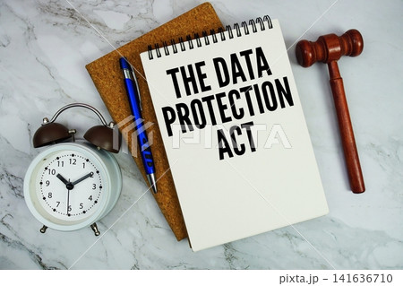 The Data Protection Act text written on notepad with pen, alarm clock and judge gavel on marble background 141636710