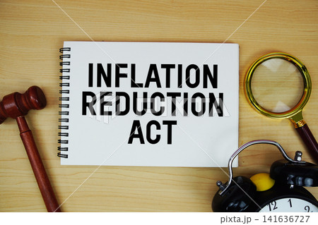 Inflation Reduction Act text written on notepad with pen, alarm clock and judge gavel on wooden background 141636727