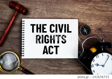 The Civil Rights Act message written on notepad with alarm clock, wood gavel and magnifying glass flat lay on wooden background The Civil Rights Act message written on notepad with alarm clock, wood gavel and magnifying glass flat lay on wooden background 141636735