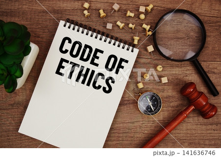 Code of Ethics message written on notepad with wood gavel and magnifying glass flat lay on wooden background Code of Ethics message written on notepad with wood gavel and magnifying glass flat lay on wooden background 141636746