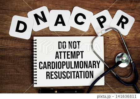 DNACPR Do Not Attempt Cardiopulmonary Resuscitation text written on notepad with stethoscope on wooden background 141636811