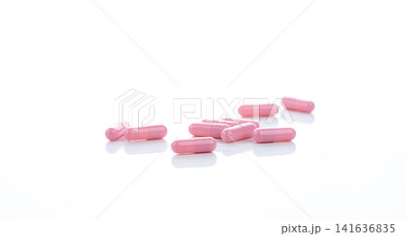 Pink capsule pills on white background. Pharmaceutical industry. Vitamins, minerals, and supplements concept. Pharmacy products. Pharmaceutical medicine. Prescription drugs. Healthcare and medicine. Pink capsule pills on white background. Pharmaceutical industry. Vitamins, minerals, and supplements concept. Pharmacy products. Pharmaceutical medicine. Prescription drugs. Healthcare and medicine. 141636835