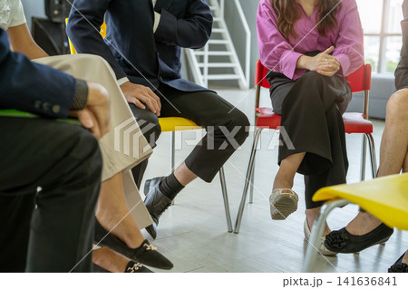 Business professionals participating in a collaborative team discussion during a corporate meeting. Workplace communication, leadership development, employee engagement, teamwork, strategic planning. Business professionals participating in a collaborative team discussion during a corporate meeting. Workplace communication, leadership development, employee engagement, teamwork, strategic planning. 141636841