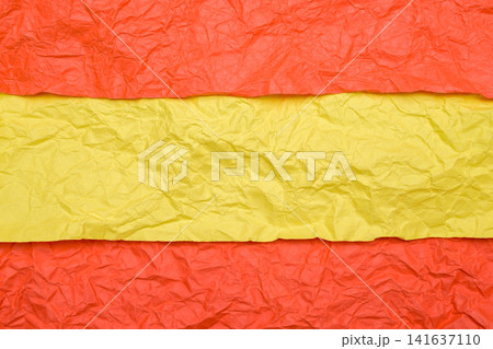 yellow and orange crumpled paper resembles the flag of spain 141637110