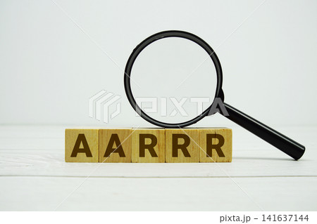 AARRR Acquisition, Activation, Retention, Referral, Revenue alphabet letters with magnifying glass on wooden background AARRR Acquisition, Activation, Retention, Referral, Revenue alphabet letters with magnifying glass on wooden background 141637144