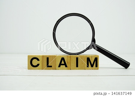 CLAIM alphabet letters with magnifying glass on wooden background CLAIM alphabet letters with magnifying glass on wooden background 141637149