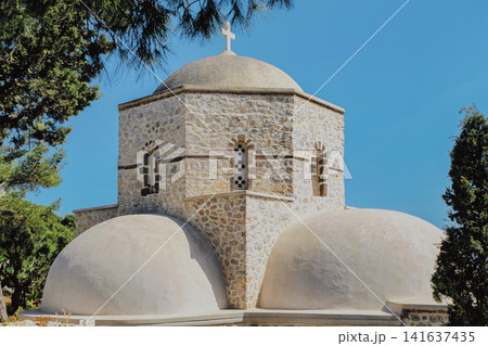 Stone Orthodox Prophet Elias monastery chapel with dome and cross on highest peak of Santorini island in Greece for landmark travel stock background photo Stone Orthodox Prophet Elias monastery chapel with dome and cross on highest peak of Santorini island in Greece for landmark travel stock background photo 141637435