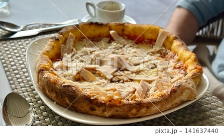 Thin Crust Pizza Served on Plate with Espresso on Table Thin Crust Pizza Served on Plate with Espresso on Table 141637440