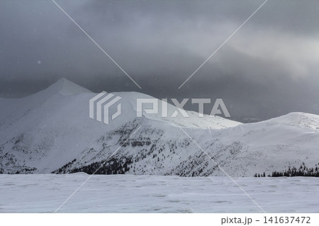 Winter mountain view in Carpathian mountains with dramatic clouds Winter mountain view in Carpathian mountains with dramatic clouds 141637472