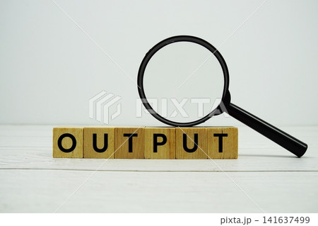 OUTPUT alphabet letters with magnifying glass on wooden background OUTPUT alphabet letters with magnifying glass on wooden background 141637499