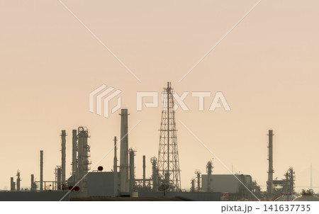 Oil refinery and petrochemical industrial plant under hazy sky with visible air pollution. Environmental impact, greenhouse gas emissions, fossil fuel production and climate change concept. Oil refinery and petrochemical industrial plant under hazy sky with visible air pollution. Environmental impact, greenhouse gas emissions, fossil fuel production and climate change concept. 141637735