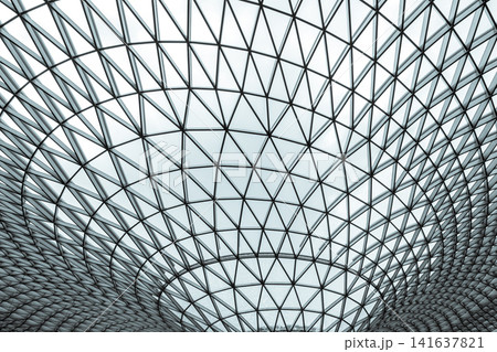 Modern glass and steel geometric dome roof with triangular pattern, futuristic architectural structure, abstract symmetry background for engineering, construction, innovation and technology design. 141637821