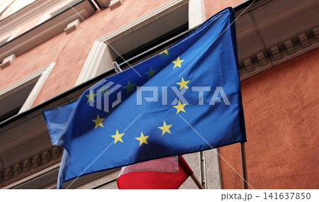 European Union Flag Waving In The City, Eu Main Symbol At A Poli European Union Flag Waving In The City, Eu Main Symbol At A Poli 141637850