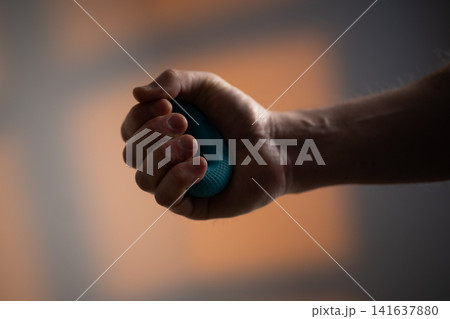Strong Male Hand Using Hand Exerciser Strong Male Hand Using Hand Exerciser 141637880