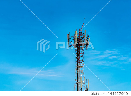Telecommunication tower with blue sky and white clouds background. Antenna on blue sky. Radio and satellite pole. Communication technology. Telecommunication industry. Mobile or telecom 4g network. 141637940