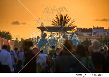 VALLETTA, MALTA - NOVEMBER 12, 2018 - The Triton Fountain In The City Gate Square with springs of water in the sunset VALLETTA, MALTA - NOVEMBER 12, 2018 - The Triton Fountain In The City Gate Square with springs of water in the sunset 141638062