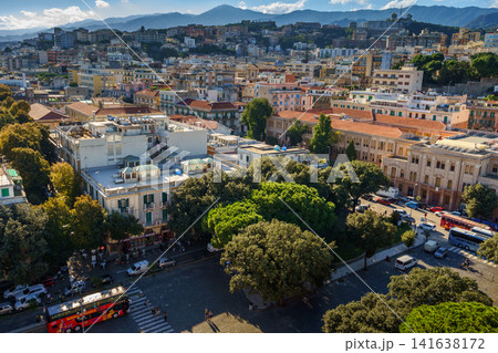 MESSINA, ITALY - NOVEMBER 06, 2018 - Panoramic top view of the local buildings with the trees, mountains and the sky in the beautiful city in Sicily MESSINA, ITALY - NOVEMBER 06, 2018 - Panoramic top view of the local buildings with the trees, mountains and the sky in the beautiful city in Sicily 141638172