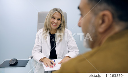 Female doctor talking to patient in cosmetic clinic Female doctor talking to patient in cosmetic clinic 141638204