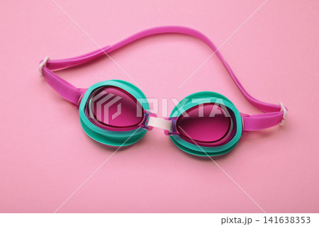 Pink swimming goggles on pink background Pink swimming goggles on pink background 141638353