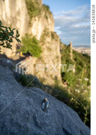 Limestone Cliff Face With Steel Abseil Bolt - Napoleonica Climbing Bouldering Area Trieste Karst, Adriatic Sea View Background, Italy Outdoor Sport Rock Climbing Limestone Cliff Face With Steel Abseil Bolt - Napoleonica Climbing Bouldering Area Trieste Karst, Adriatic Sea View Background, Italy Outdoor Sport Rock Climbing 141638616