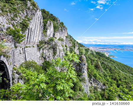 Dramatic Limestone Rock Pillars And Historic Stone Arch On Napoleonica Trail - Trieste Karst Climbing Bouldering Area, Adriatic Sea View, Italy Outdoor Adventure Hiking Dramatic Limestone Rock Pillars And Historic Stone Arch On Napoleonica Trail - Trieste Karst Climbing Bouldering Area, Adriatic Sea View, Italy Outdoor Adventure Hiking 141638660