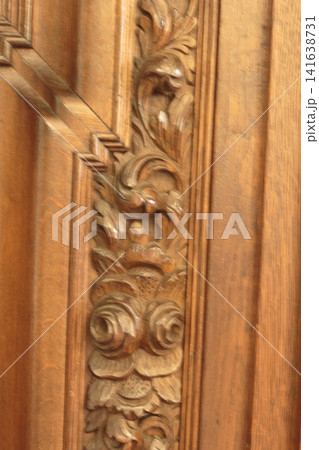 Intricate Carved Wooden Ornament on Vintage Furniture Surface Intricate Carved Wooden Ornament on Vintage Furniture Surface 141638731