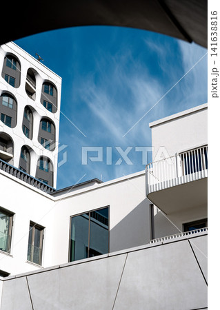 Modern Munich Residential Complex - Upward Perspective - Contemporary White Architecture Against Blue Sky 141638816