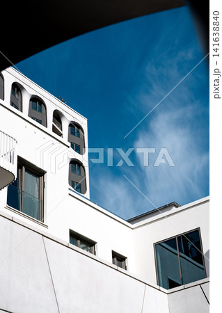 Modern Munich Residential Complex - Upward Perspective - Contemporary White Architecture Against Blue Sky 141638840
