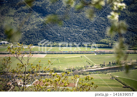 Adige River Valley And Dolci Village Viewed From Placca Del Forte San Marco: Panoramic Spring Landscape Near Lake Garda Adige River Valley And Dolci Village Viewed From Placca Del Forte San Marco: Panoramic Spring Landscape Near Lake Garda 141639057