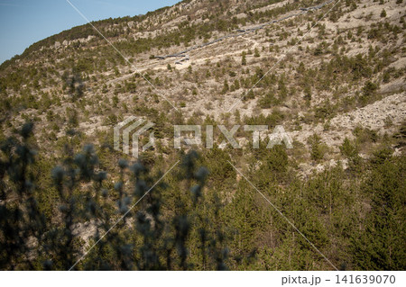Dinosaur Footprints Trail With Staircase On Rocky Slope: Paleontological Site With Jurassic Tracks Near Mori And Rovereto Near Lake Garda In Trentino Italy Dinosaur Footprints Trail With Staircase On Rocky Slope: Paleontological Site With Jurassic Tracks Near Mori And Rovereto Near Lake Garda In Trentino Italy 141639070